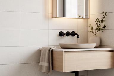 Newly tiled bathroom wall with black fixtures and a wall-mounted vanity